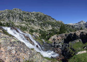 Waterfall in high mountains at Marcadau valley, Pyrenees National Park, department of Hautes-Pyrenees, France