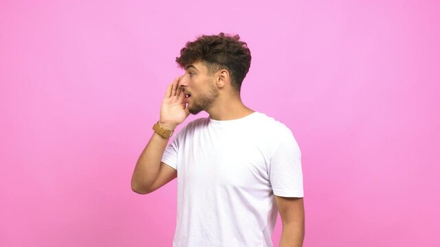 Young arab man whispering gossip undertone, trying not to be heard