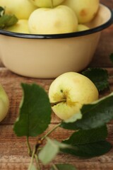 Delicious green apples with leaves on the table