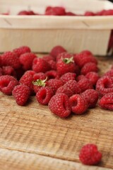 Juicy raspberries on a wooden table macro