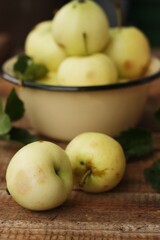 Delicious green apples with leaves on the table