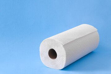Roll of paper towel on blue with copy space