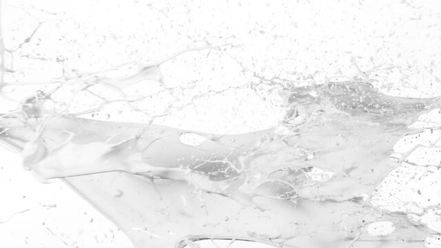 Super slow motion of flying milk splashes on white background. Filmed on high speed cinema camera, 1000 fps.