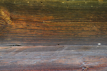 Fototapeta premium Sunburnt wood, aged by wind and time. Old wood texture. Weathered cut of tree rings.