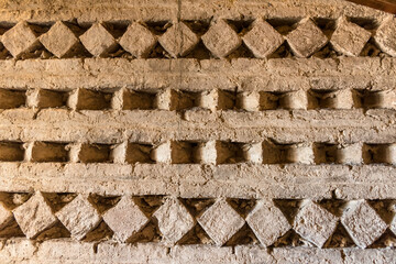 Fragment of a pattern on a stone wall in the corridor of a medieval tower in San Gimignano, Italy