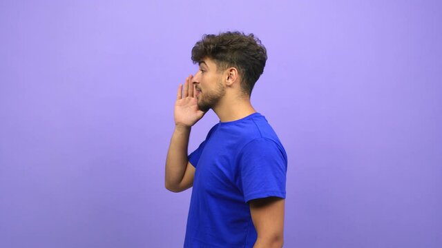 Young arab man whispering gossip undertone, trying not to be heard