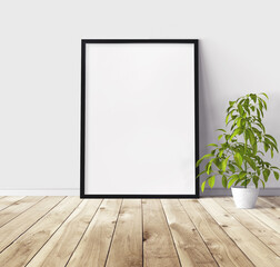 Fototapeta na wymiar White vertical poster with black wooden frame standing on floor. Template for you design.