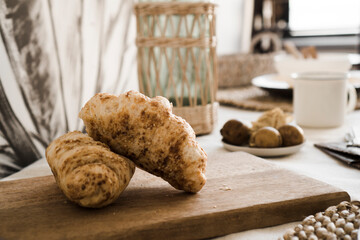 A croissant on the table. Breakfast in the kitchen - Light Scandinavian style kitchen
