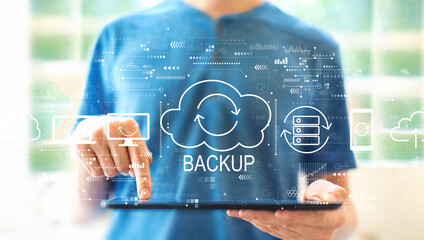 Backup concept with young man using a tablet computer