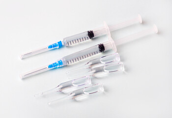 Fototapeta premium Medical concept with a syringe and covid-19 vaccine ampoule.