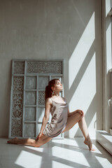Fototapeta premium Portrait of gorgeous young woman practicing yoga indoor. Beautiful girl practice in class.Calmness and relax, female happiness.