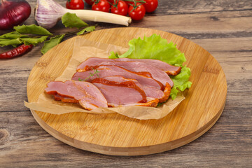 Sliced smoked duck breast served salad