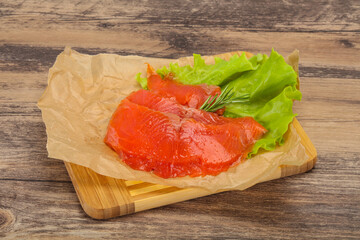 Sliced salmon fillet served rosemary