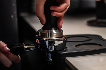 close up of a hand holding a coffee grinder