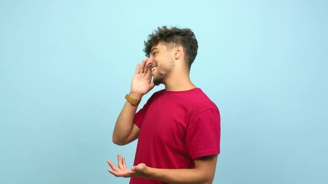 Young arab man whispering gossip undertone, trying not to be heard