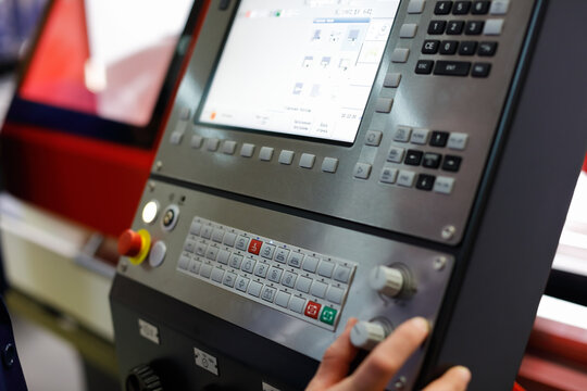 worker controls the operation of the CNC machine