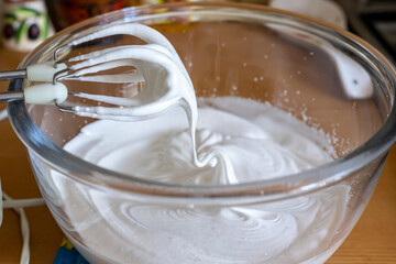 Egg whites beaten to a frothy stage. Whipped egg whites for meringue.