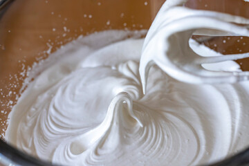 Egg whites beaten to a frothy stage. Whipped egg whites for meringue.