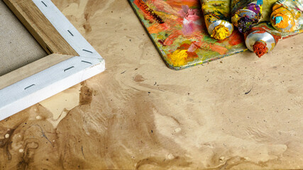 Tubes of multicolor oil paint on canvas close-up.