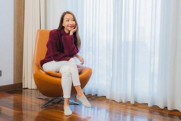 Portrait beautiful young asian woman smile relax on sofa