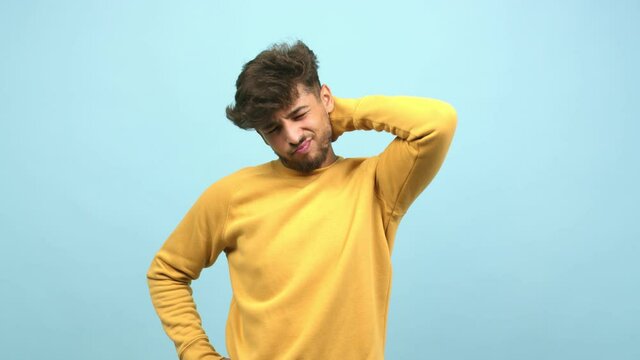 Young arab man tired and very sleepy, looking comfortable and relaxed, exhausted gesture