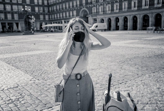 Tourist In Spain Talking On Mobile With Face Mask Worried About Travel Restrictions Quarantine