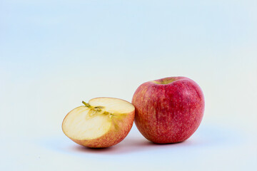 Red apple fruit with haft apple isolated on white background with clipping path