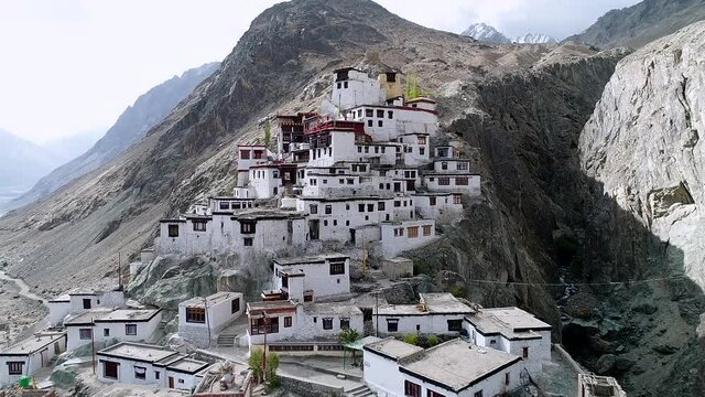 ancient buddhist monastery on a remote rocky mountain region in leh ladakh, india. aerial footage.