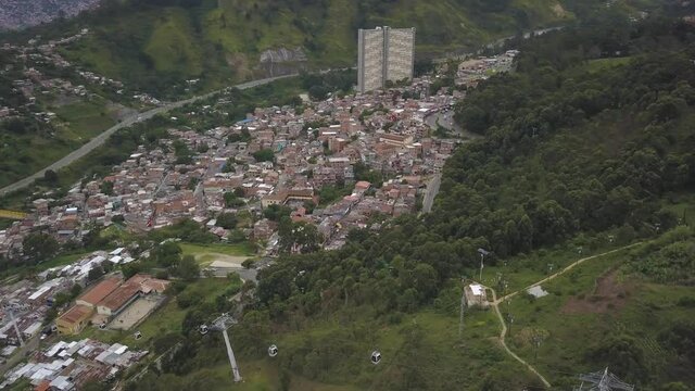 Medellin City Colombia Drone Aerial View of Metrocable Funicular Gondola Project Above Valley on Cloudy Day