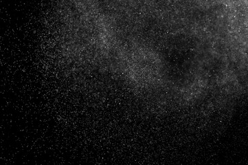 Obraz premium Abstract splashes of water on black background. Freeze motion of white particles. Rain, snow overlay texture.