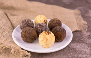 
Cocoa balls, candy with chocolate balls on a plate.