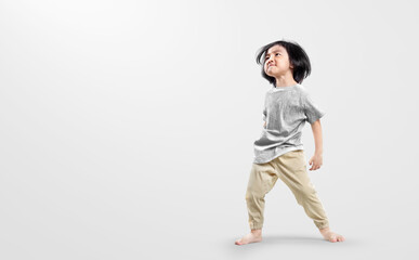 Happy asian boy actively, exicte and dancing against isolated on clean bright background.  Education concept for school.
