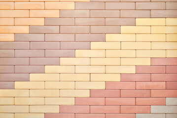 Texture of brick wall. new brickwork. Samples of wall or fence are presented at exhibitions. Brown and orange brick close up.