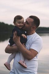 Fototapeta na wymiar Father kissing his little child