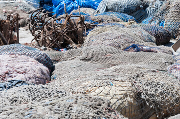 Fishing nets dry in the sunlight / Piles of fishing nets dry in the sunlight.