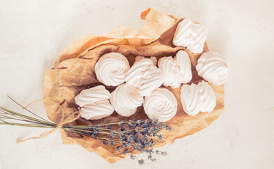 Homemade russian zephyr made of apples, raspberry and blackberry on white concrete background isolated. Free copy space. White marshmallow on the brown beige paper