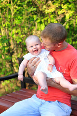 Fototapeta premium Dad and daughter in the park. Portrait of dad and child.