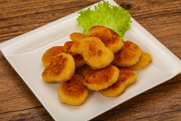 Fried chicken nuggets served salad leaves