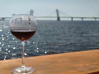 Glass of wine on the background of the bridge in St. Petersburg, Russia