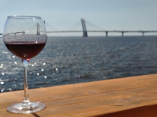 Glass of wine on the background of the bridge in St. Petersburg, Russia