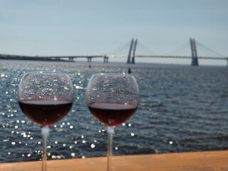 Glass of wine on the background of the bridge in St. Petersburg, Russia