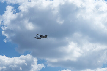 Daylight. large aircraft accompanied by combat vehicles. blue sky