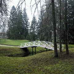 small white bridge over the moat in the park