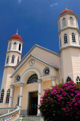 Church of San Rafael in Zarcero Costa Rica with flowering Bouganvilla bush