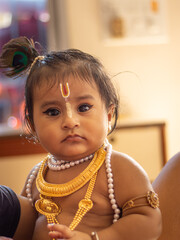 Cute baby dressed up like lord krishna/gopal in the occasion of janmashtami stock image.