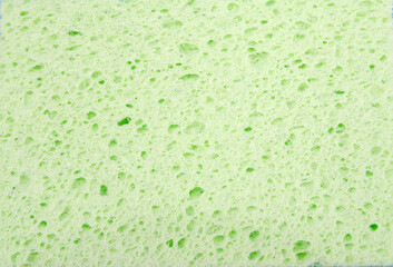 Background green kitchen sponge.Green washing sponge texture