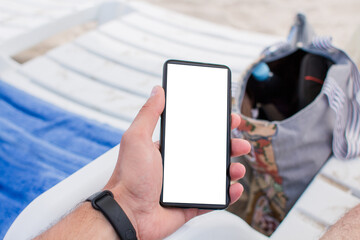 smartphone in hand on the beach