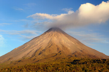 Cloud forming from smoke of Arenal Volcano Costa Rica at sundown