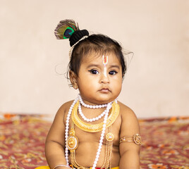 Cute baby dressed up like lord krishna/gopal in the occasion of janmashtami stock image.