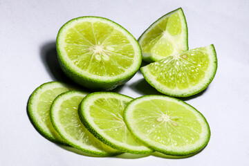 Green lime wedge on white background